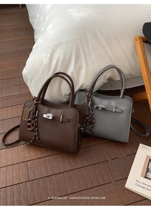 Detail of retro leather handbags with metallic twist locks and minimalist charms
