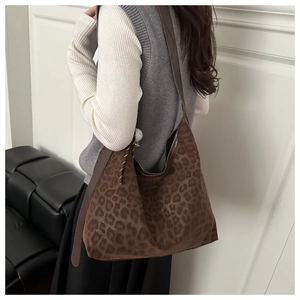 Leopard print tote bag detail showing soft suede texture and baseball charm decoration