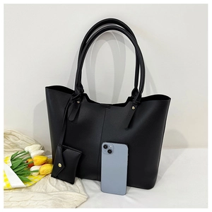 Large black tote bag with matching pouch and phone for size reference on white background