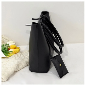 Side view of matte black large tote bag with matching small coin purse and soft tulips