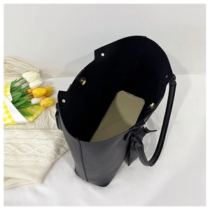 Interior view of large black tote bag showing spacious storage and magnetic closure