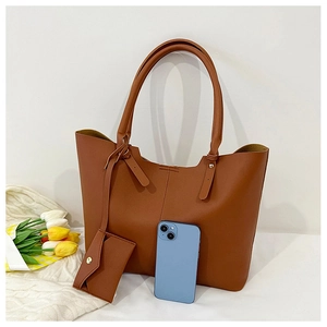 Brown large capacity tote bag and small envelope pouch with smartphone for size reference