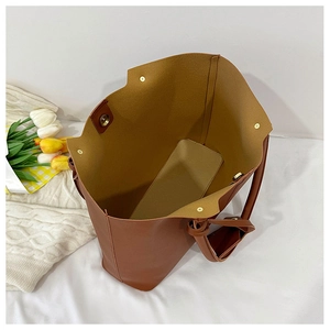 Top view of brown PU leather tote bag with gold magnetic buckle and interior base plate
