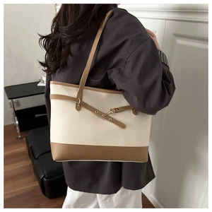 Detail view of large tote bag with lychee texture and caramel contrast straps