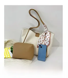 Detail of off-white tote bag and brown pouch with decorative polka dot scarf accessory