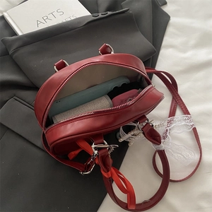 Chic red semi-circular leather handbag with internal space for phone and accessories