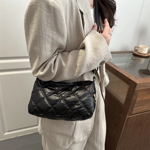 Quilted black puffer crossbody bag with adjustable strap and large capacity for winter