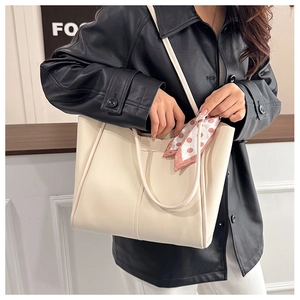 Chic cream tote bag with patterned scarf detail and slender shoulder strap for daily commuting