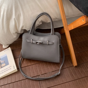 Minimalist grey faux leather handbag with lychee texture and silver twist lock detail