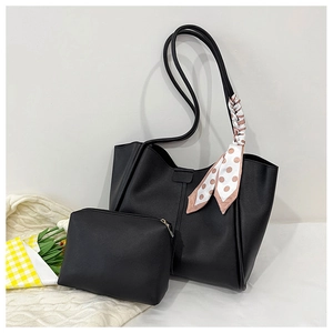 Detail of black pebbled leather tote set with matching pouch and decorative floral scarf