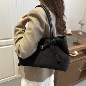 Minimalist black faux suede tote bag for women featuring stylish metal buckle and strap