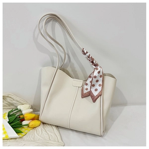 Detail of off-white tote bag with elegant polka dot scarf handle and tulip decoration