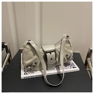 Dettaglio della borsa a spalla in pelle grigia vintage con fibbie e borchie in metallo