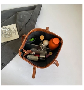 Interior view showing the large capacity and storage of the brown leather tote bag