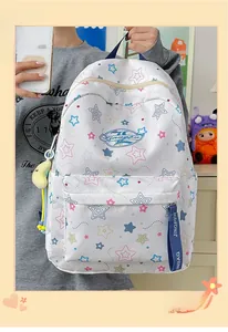 Detail of white star-patterned backpack with colorful stars and blue ribbon handle