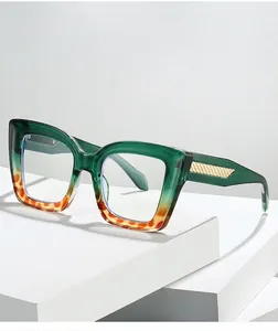 Detail of emerald green gradient cat-eye frame with gold textured metal temples