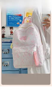 Detailed view of white and pink marble pattern backpack with starry plush charm accessory