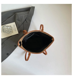 Top view of large brown tote bag interior with zipper closure and spacious compartments