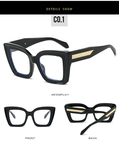 Detail shot of black thick-frame glasses featuring iconic gold woven metal temple accents