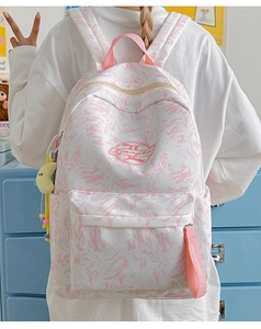 Detailed view of pink marble pattern backpack with pink webbing and star charm
