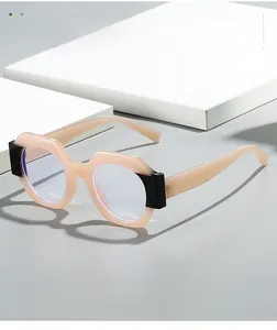Detail view of peach pink geometric glasses with stylish black contrasting temple hinges