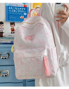 Detail of pink marble backpack featuring a large zipper pocket and logo strap