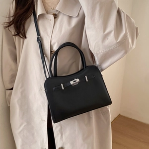 Classic black leather satchel bag with silver metal lock and adjustable shoulder strap