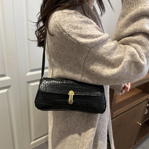 Classic black crocodile pattern baguette bag with golden U-shaped clasp and shoulder strap
