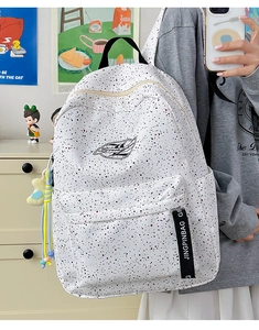 Detailed view of large capacity waterproof backpack with ink splash pattern and star charm