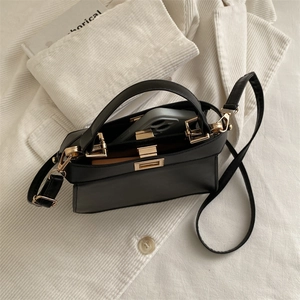 Minimalist black leather square handbag with gold hardware and phone storage space
