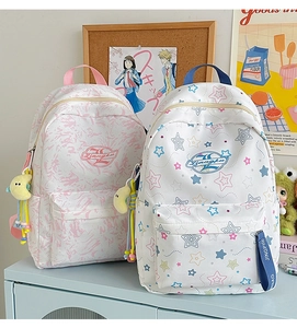 Detail of pink marble and star pattern backpacks with cute moon plush keychains