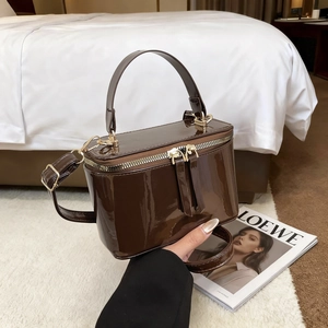 Deep brown glossy patent leather box bag with gold hardware and top handle for women