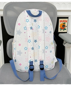 Detailed back view of white waterproof backpack with colorful star prints and navy straps