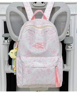 Detailed close-up of pink marble pattern backpack with cute moon plush charm accessory