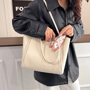 Cream large capacity tote bag with silk scarf accessory shown on a model's shoulder