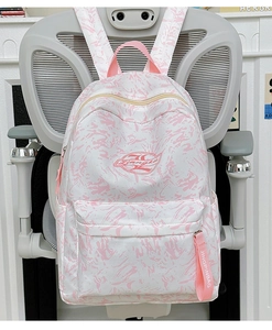 Detailed view of waterproof student backpack with pink accents and large front zipper pocket