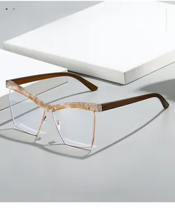 Close-up of cat-eye frames with marble texture and gold metal rim on a white platform