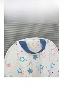 Detail view of the durable blue nylon padded handle on a star-patterned backpack