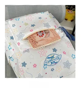 Detail showing front pocket of white star pattern backpack with pink notebook