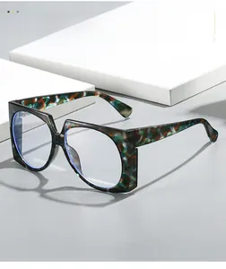 Detail of oversized retro frames with tortoiseshell camo texture on a geometric pedestal