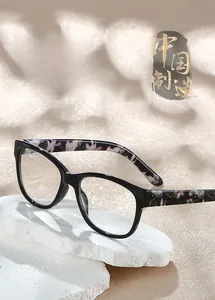 Detail shot of stylish PC reading glasses with marble floral pattern temples on stone