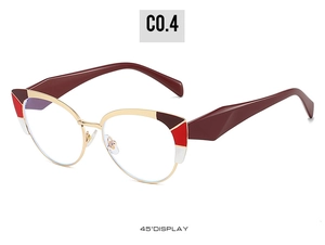 Detail of stylish cat-eye glasses with golden metal frame and burgundy temples at 45-degree angle
