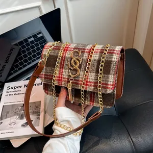 Classic plaid chain shoulder bag with gold hardware and leather handle in a lifestyle setting