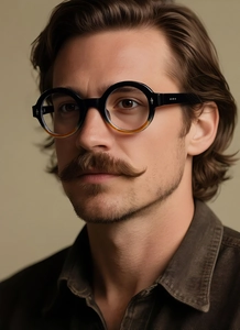 Close-up of retro round gradient frame glasses worn by a male model in warm studio lighting