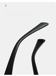 Close-up of sleek black metal eyeglass frames showing curved mirror legs for comfort