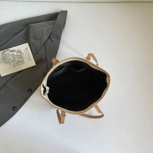 Minimalist beige tote bag featuring a spacious interior with pockets for daily commute