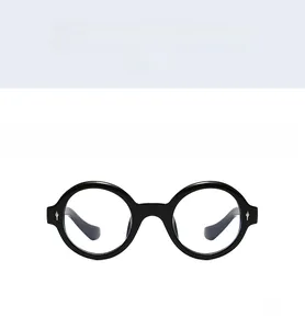 Front view of retro round black sunglasses with silver rivet accents and UV protection