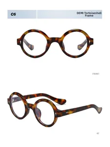 Detail view of round tortoiseshell glasses frames with silver metal rivets on white background