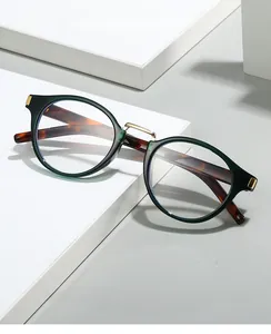 Retro oval sunglasses with dark green tortoiseshell frames and gold metal details