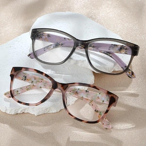 Chic marble pattern reading glasses with floral temples on natural stone and sand base